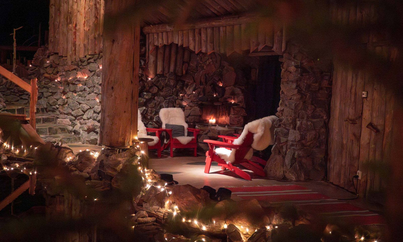 A cozy fireplace area with armchairs at Piparina restaurant.