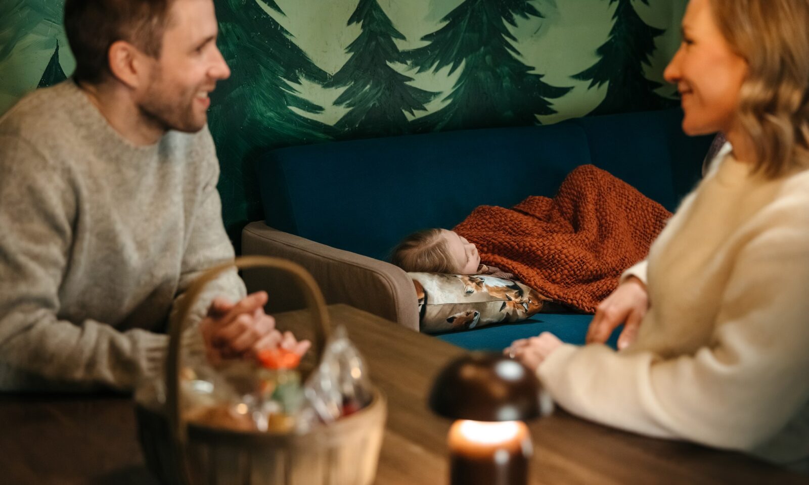 A child having a nap in the gingerbread cabin.