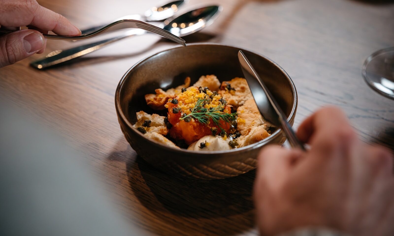 A person enjoying meal in the gingerbread cabin.