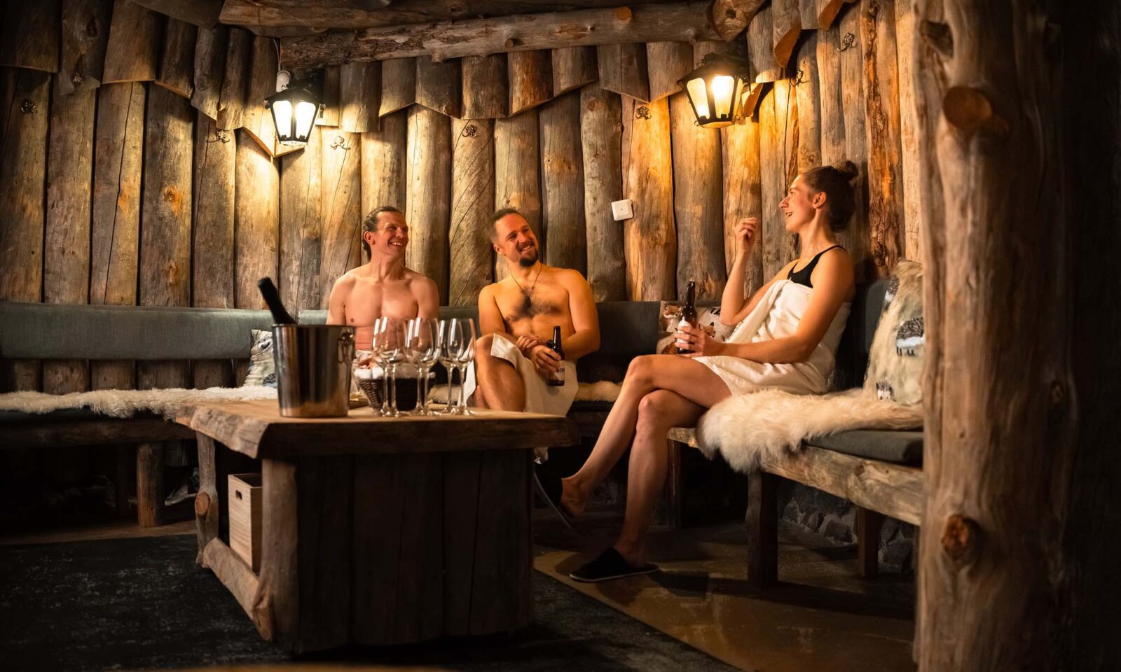People in fireplace lounge of the sauna.